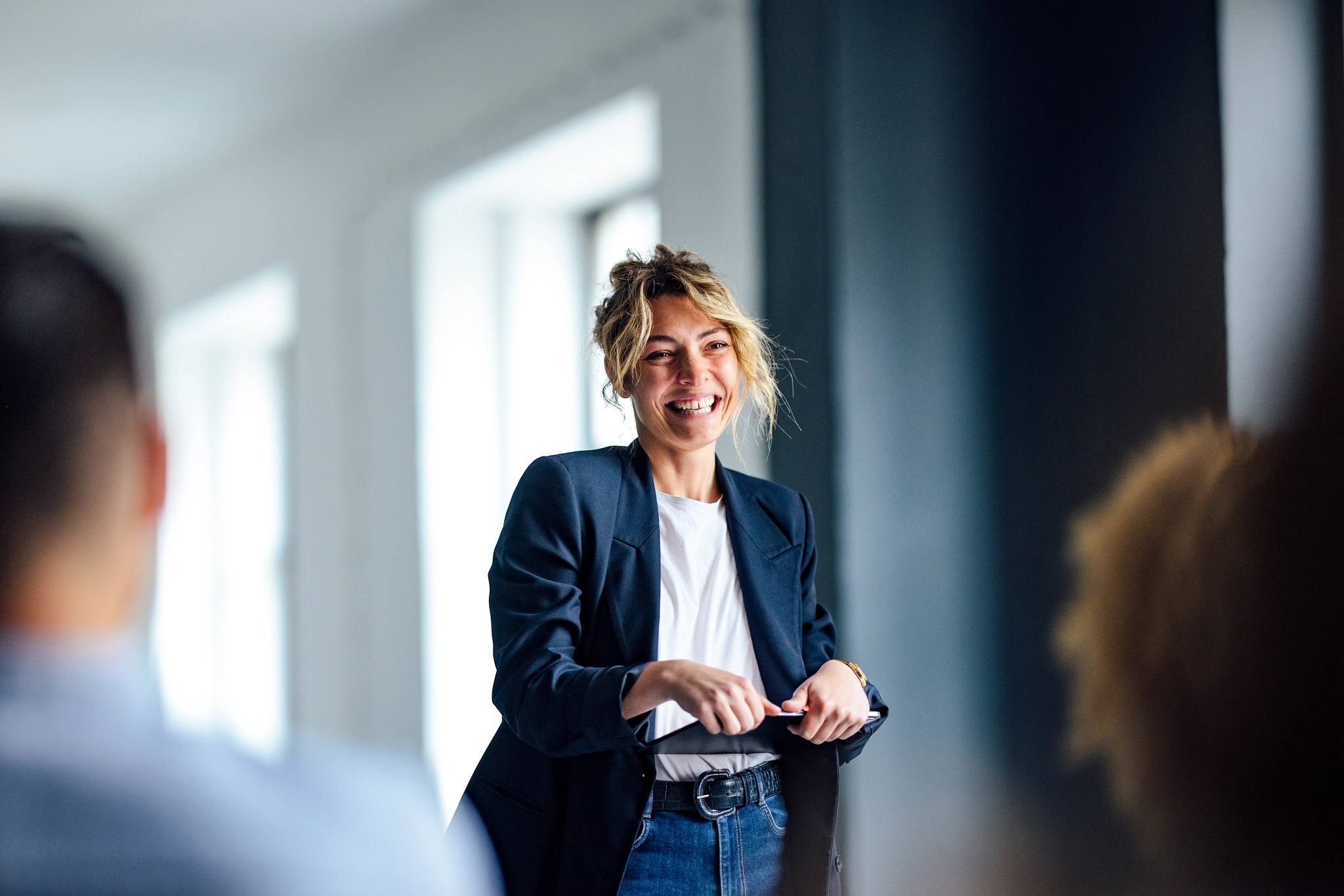 Female speaker delivering a presentation to an audience.