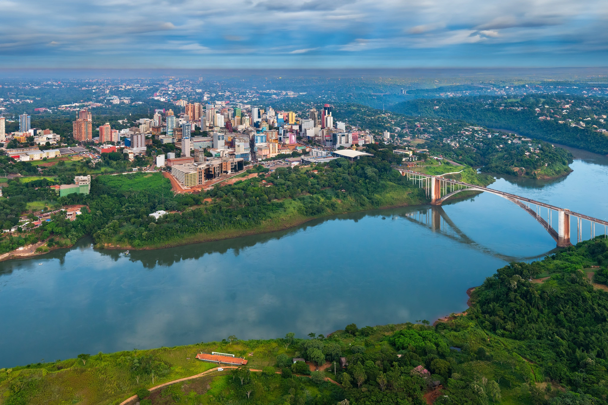 Aerial view of a vibrant Colombian city showcasing urban landscapes and greenery under a clear blue sky