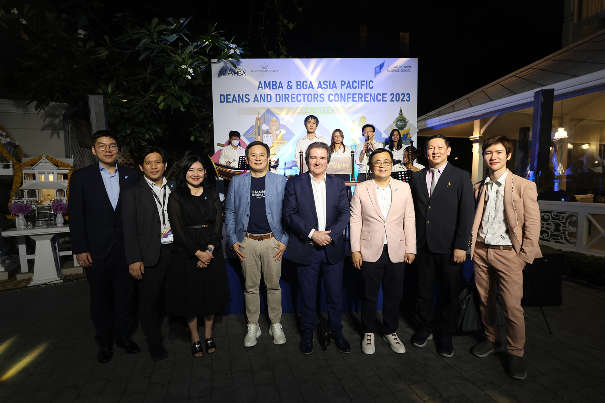 A group of people standing in front of a sign