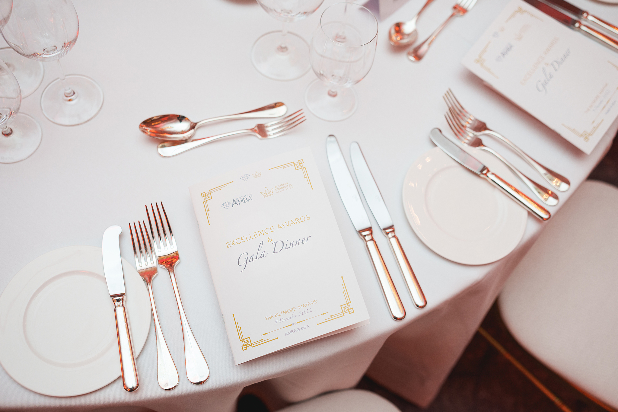 A table with silverware and a menu