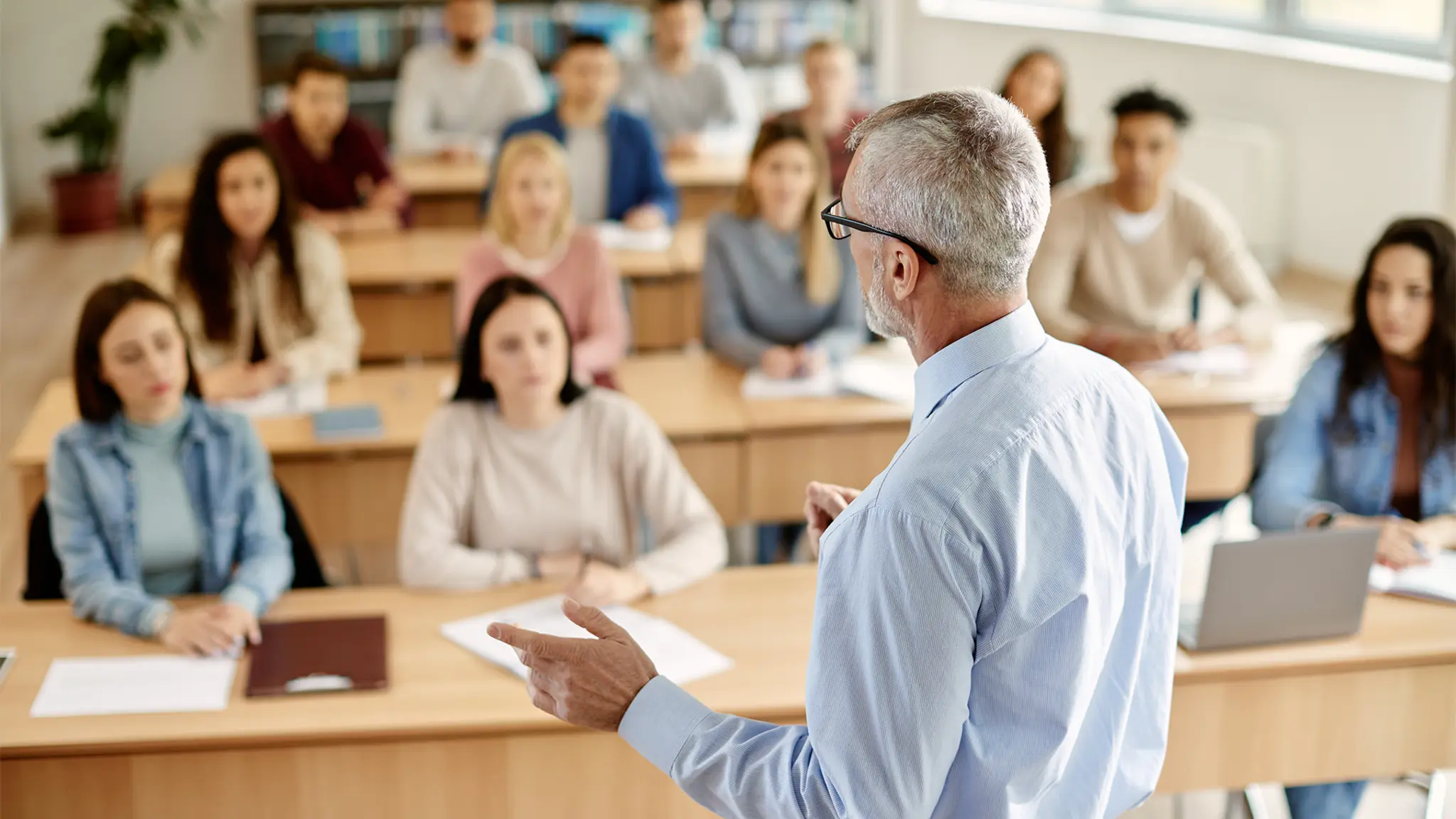 A speaker standing in front of a group of students