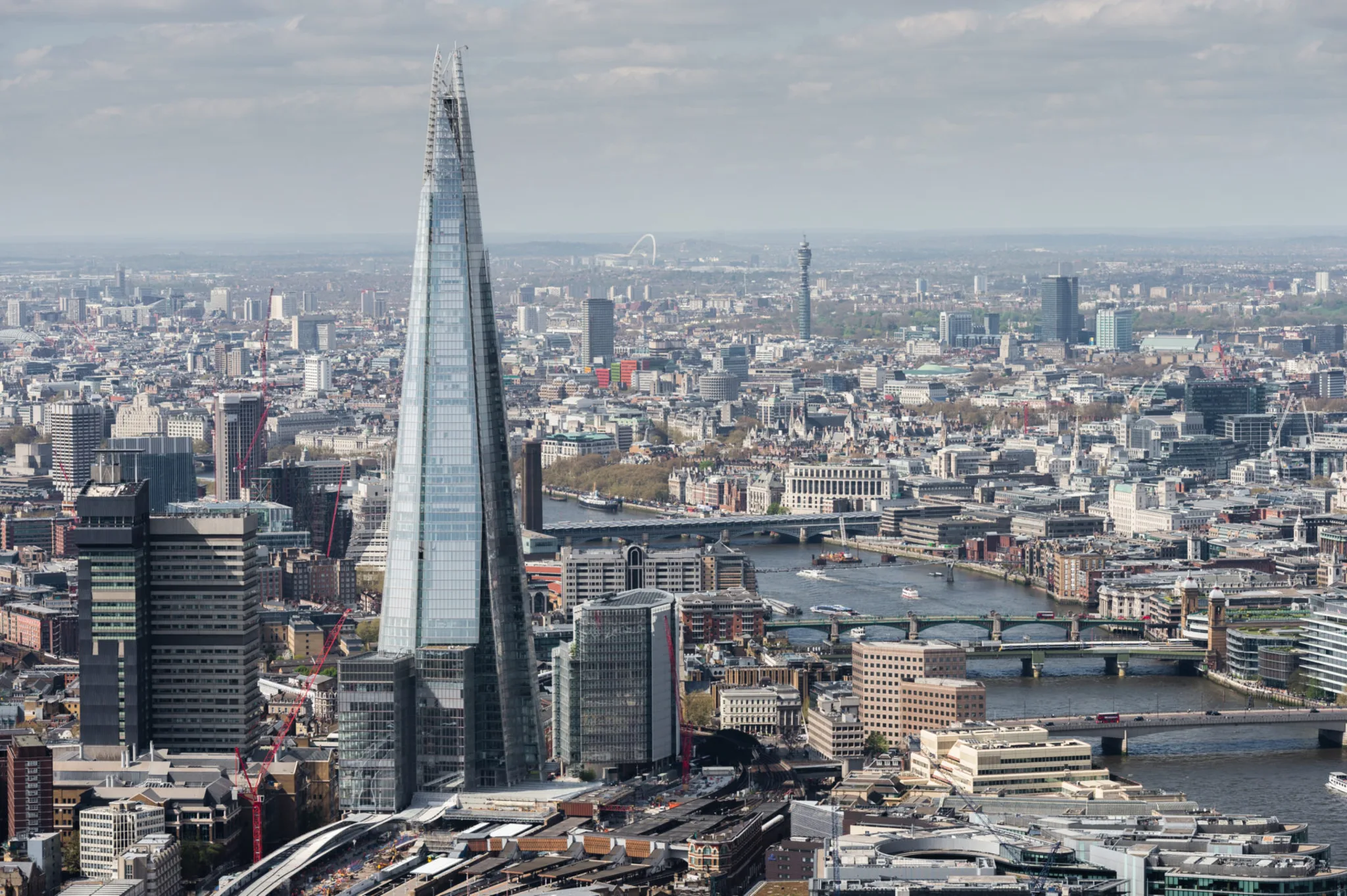 A view of The Shard, a tall skyscraper in London, showcasing its distinctive glass façade against the skyline.