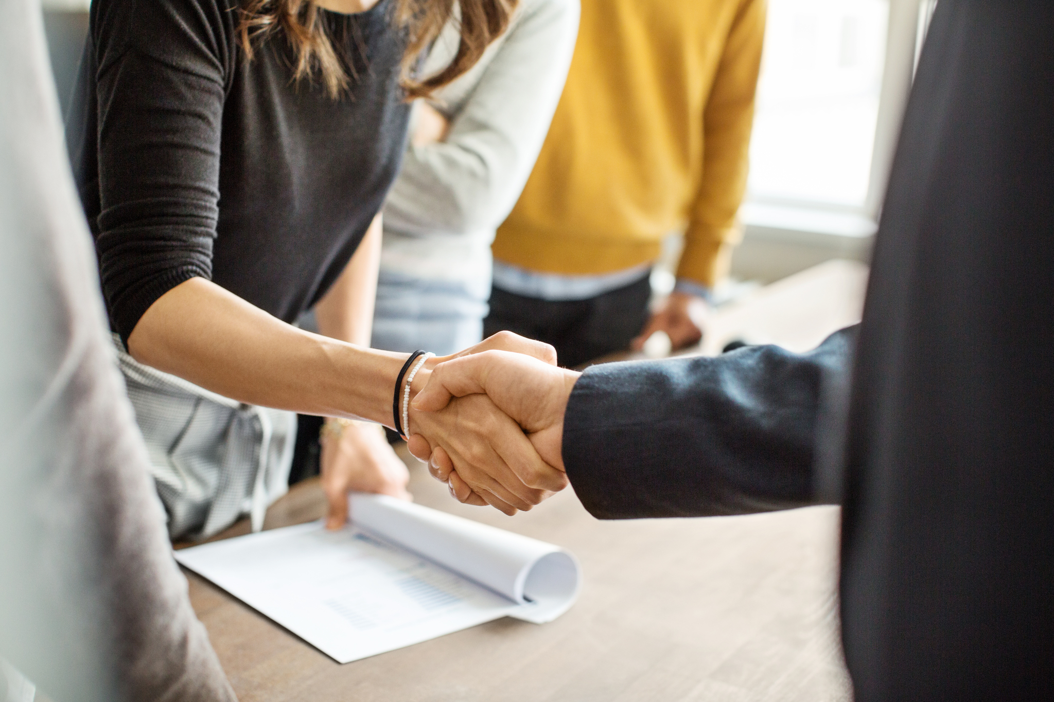 A person and person shaking hands