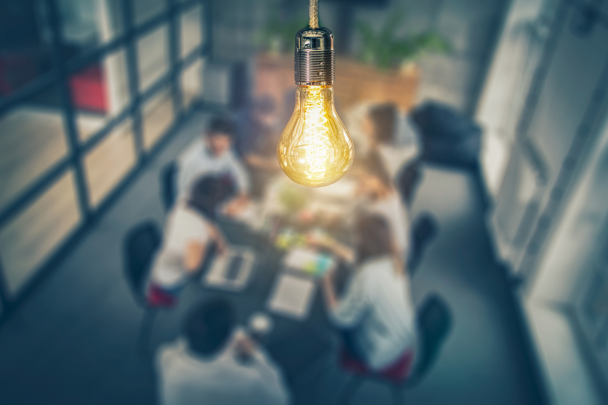 A light bulb over a group of people