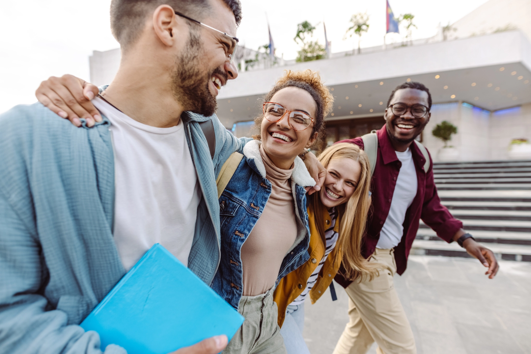 A group of students with their arms around their shoulders