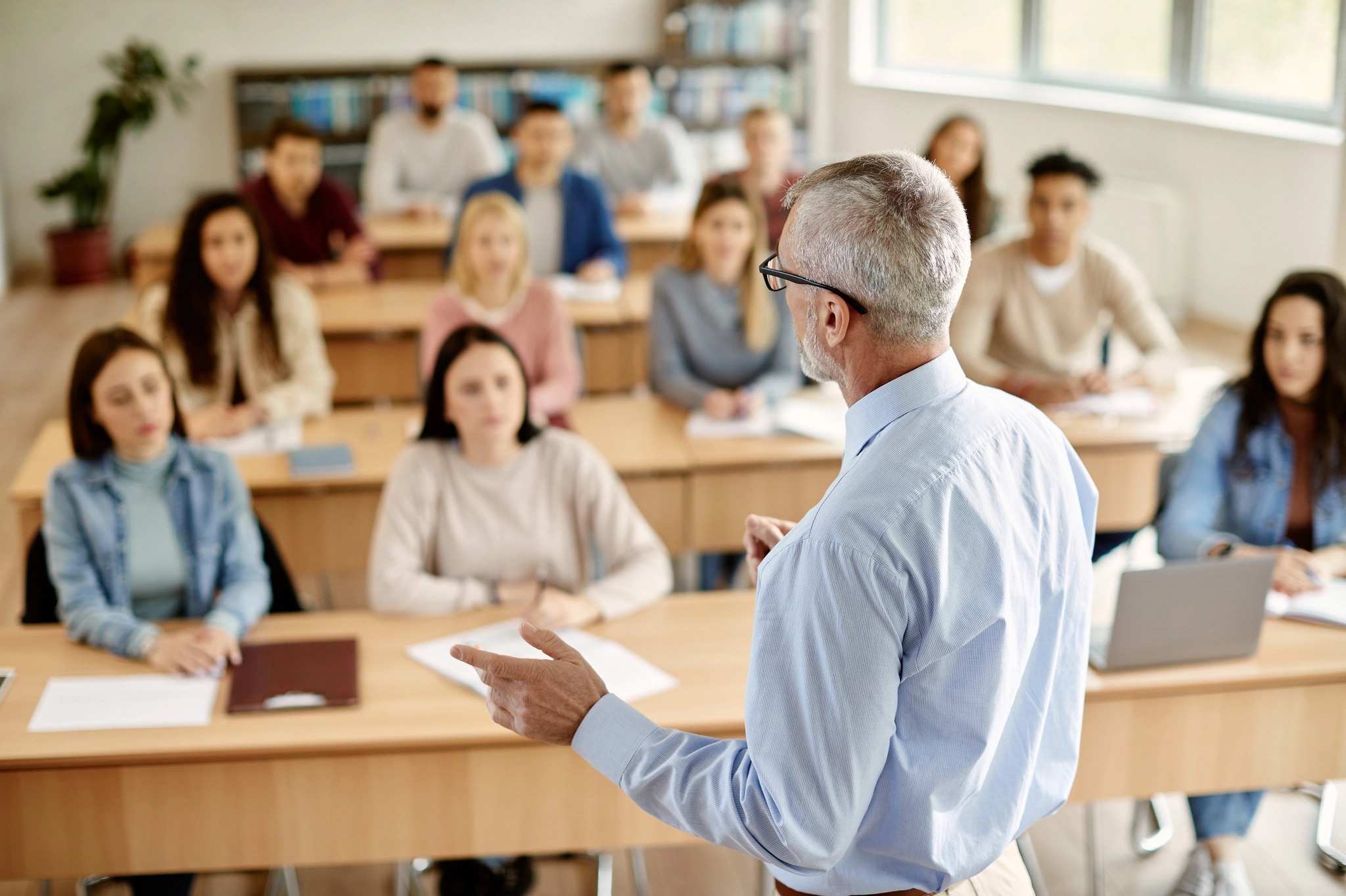 A university lecturer presenting to students.