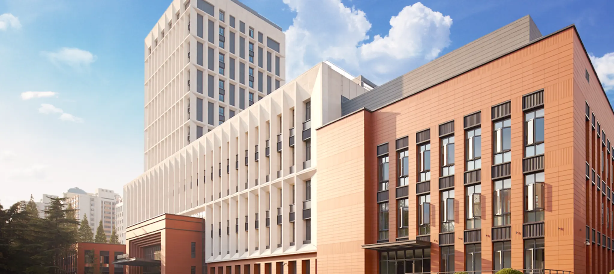 a group of buildings with blue sky and clouds